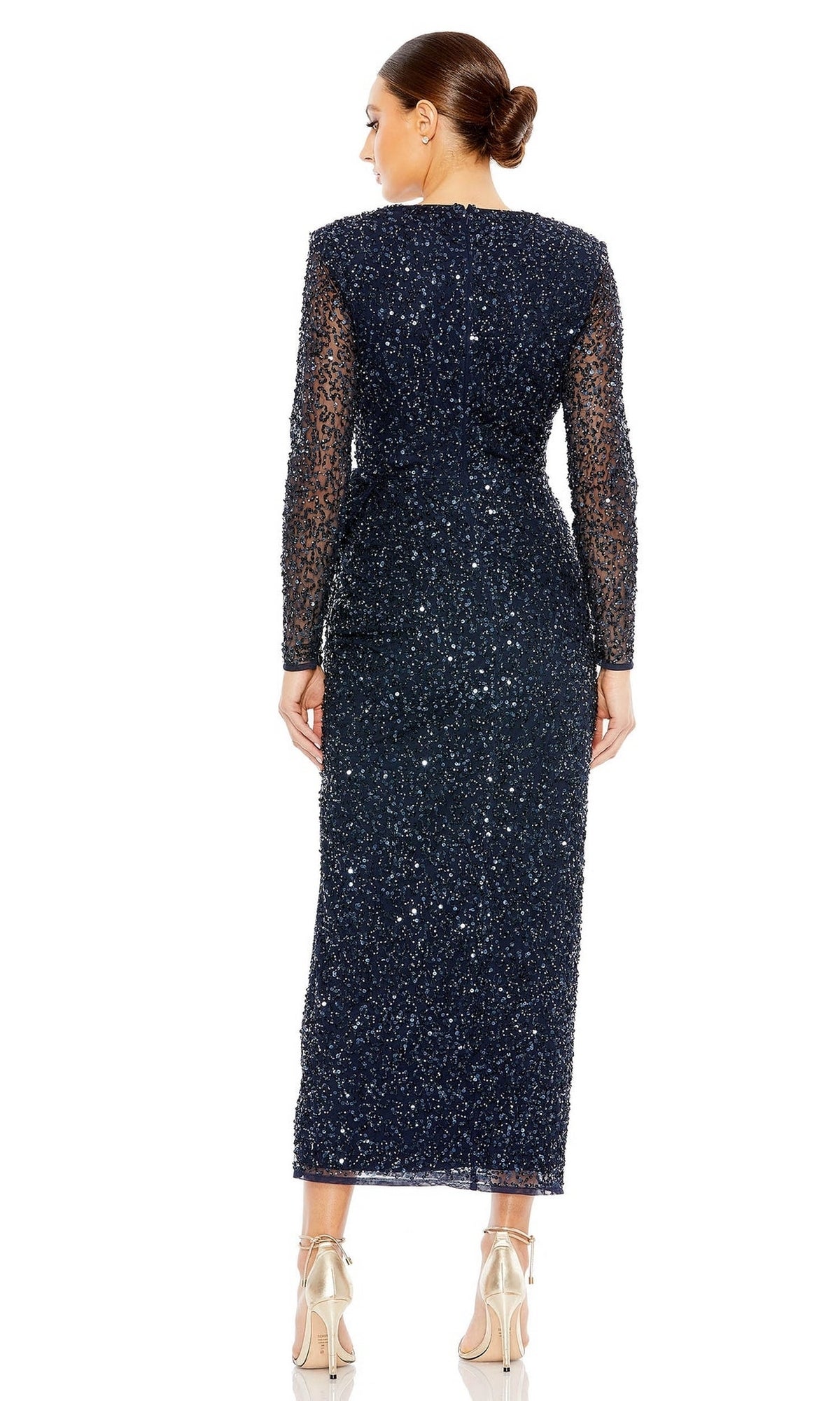 A woman faces away, wearing the Mac Duggal 10558 Blue Midi Wedding-Guest Dress with sequin embellishments and beige heels, set against a plain white background.